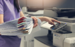 Woman scanning paper files