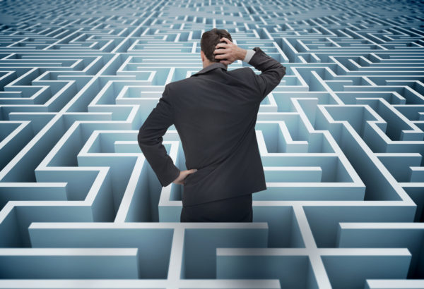 A business stuck in a maze confused and unable to find what he needs to.