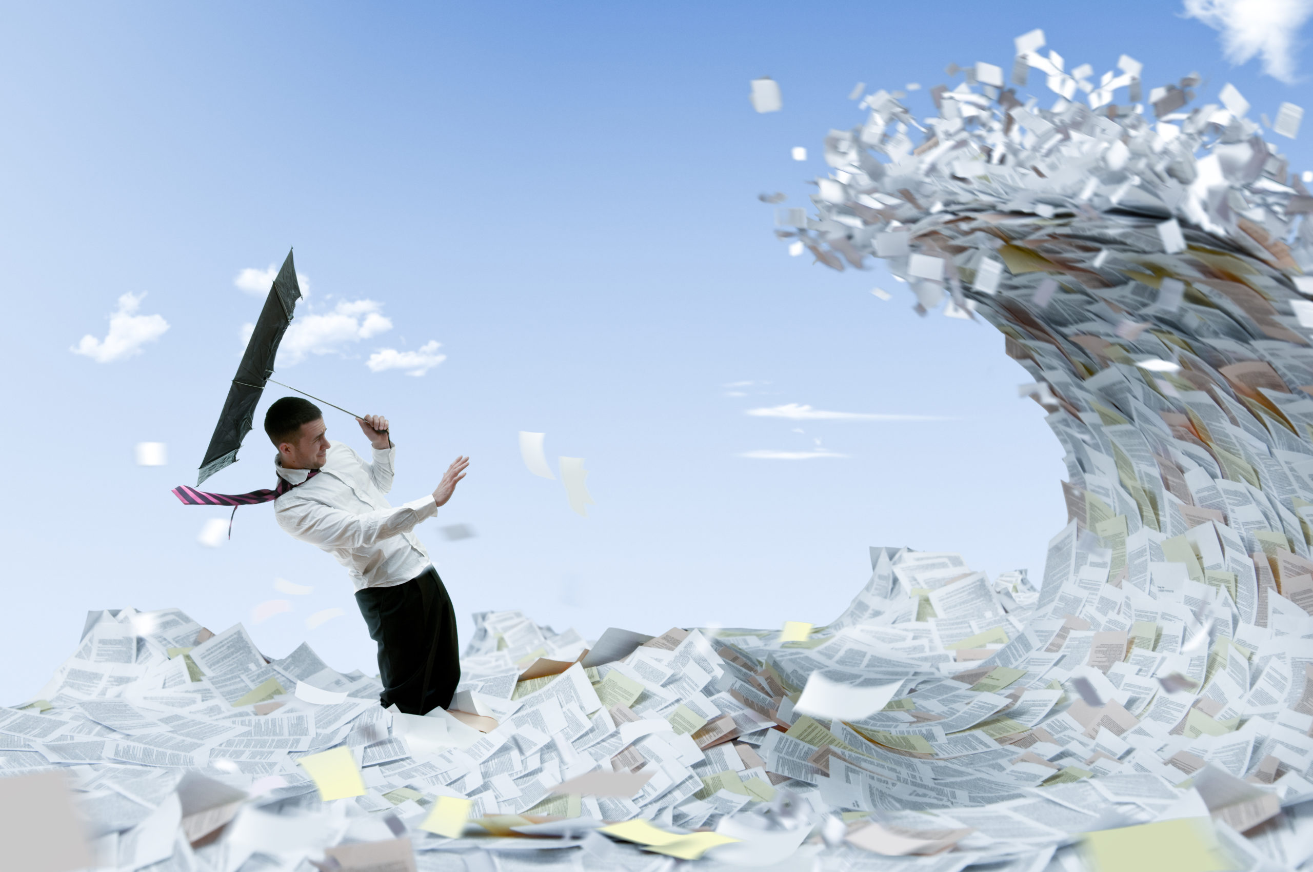 A businessman overwhelmed by a large amount of paper