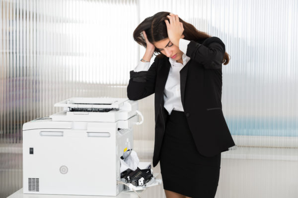 Businesswoman stressed about a paper jam
