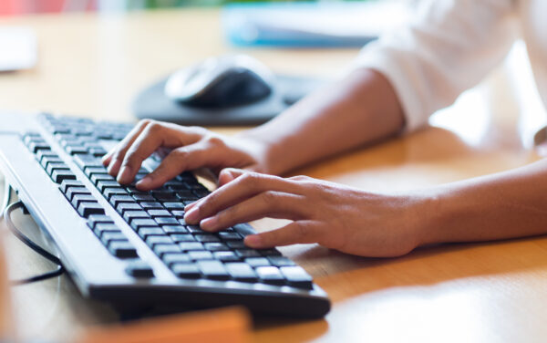 Female typing on a keyboard