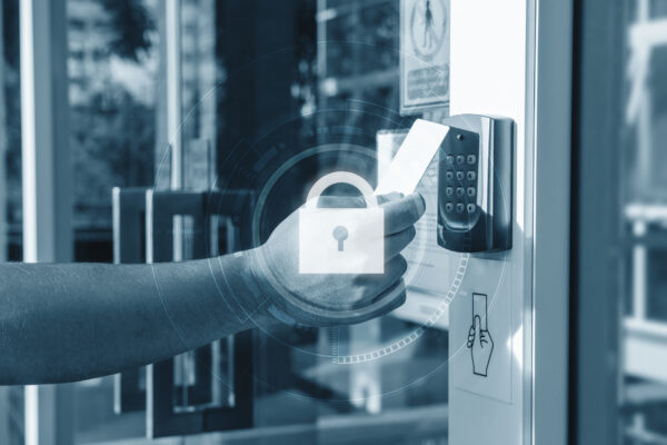 Employee using security key card with pin pad to open a secure building door