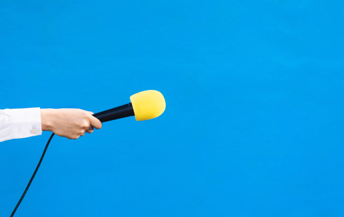 Person holding a microphone for an interview