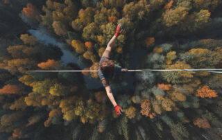 Tightrope walker over a forest