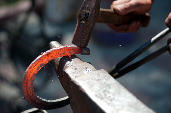 Blacksmith striking a horseshoe