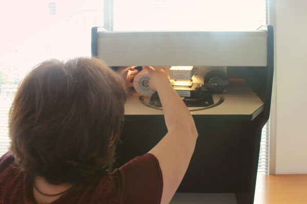 Librarian Woman preparing microfilm reader