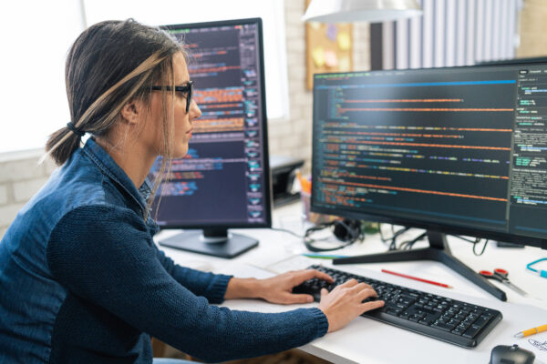 Female software engineer writing code