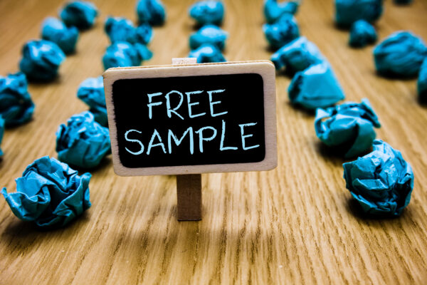 Free sample sign on chalkboard with crumpled blue paper balls around it