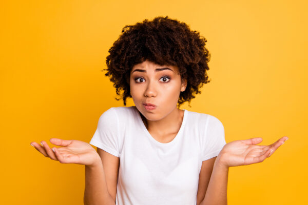 Woman shrugging her shoulders in a "I don't know" gesture