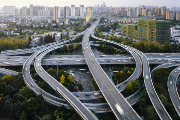 Freeway overpass and on-ramps in a city, signifying the complexity of logistics
