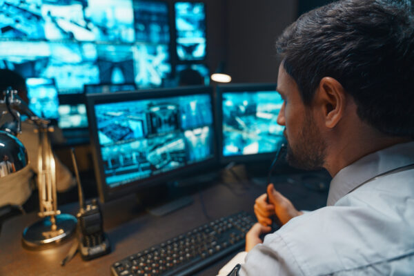 Security person watching cameras on a computer screen