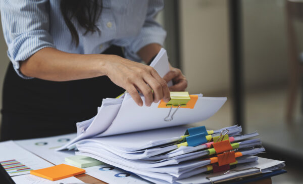 Businesswoman working through stacks of files