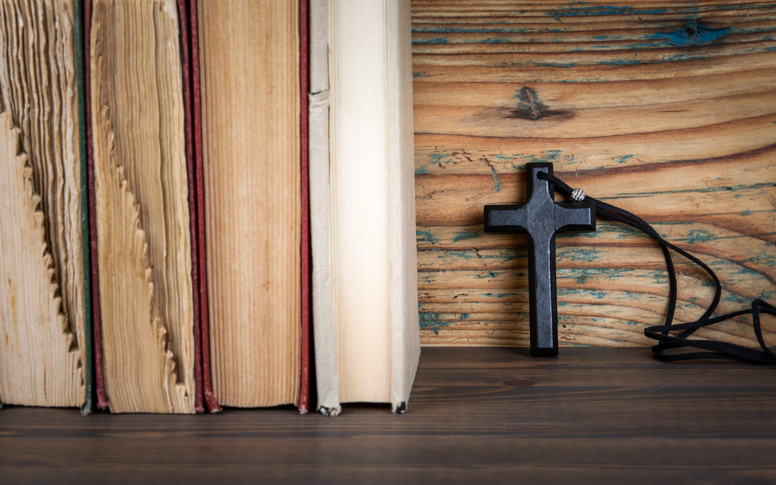 Wooden cross with old books