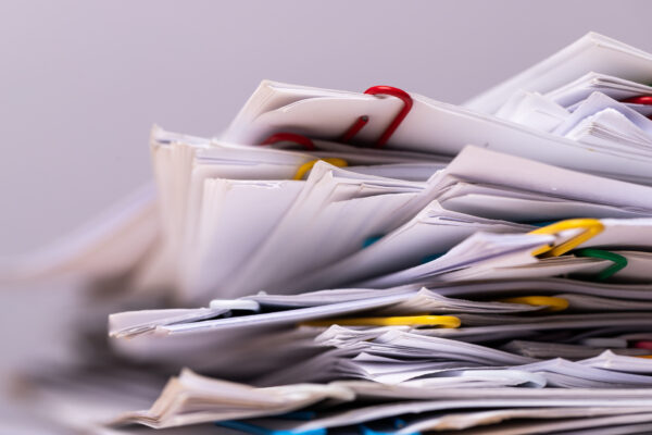 Stack of files piled on a desk