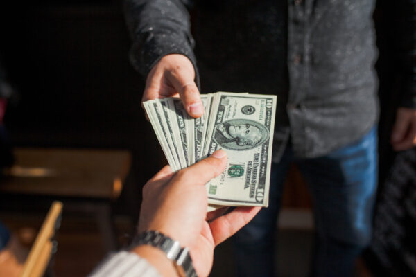 Two people exchanging cash money