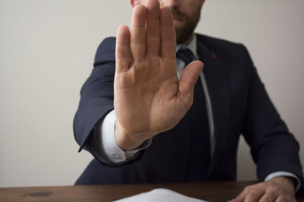 Businessman with hand up indicating to stop