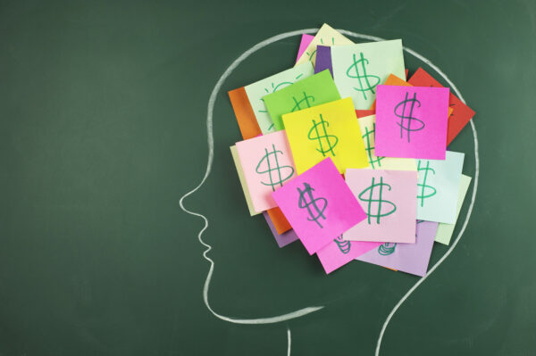 Blackboard drawing of a person's head with dollar signs on sticky notes