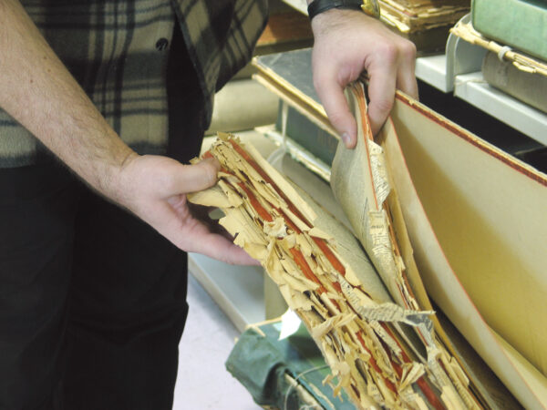 Person showing damaged paper files