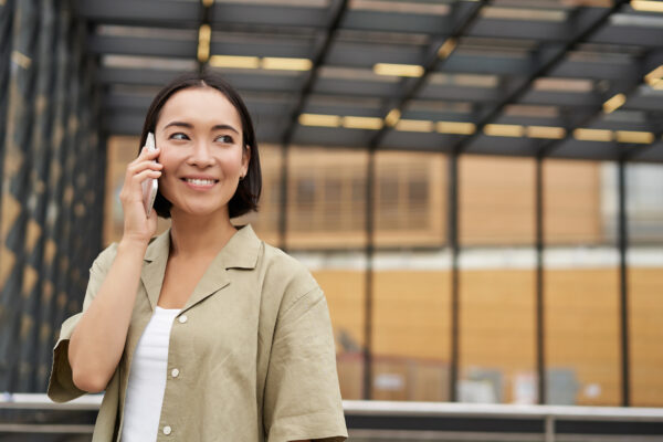 Happy young businesswoman talking on a cell phone