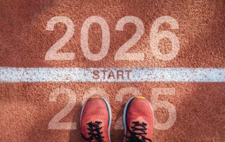 New year 2026 concept, beginning of success. Text 2026 written on asphalt road and male runner preparing for the new year. Concept of challenge or career path and change.