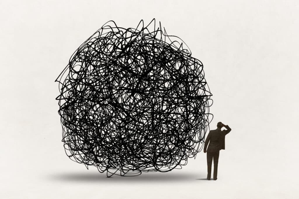 Man Looks Past Confusion A man looks past the confusion that is represented by a large tangled ball.