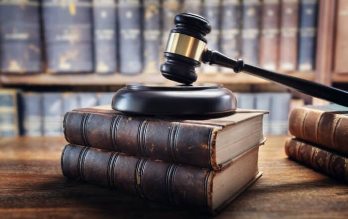 Judge gavel and law books in court, law and justice background concept