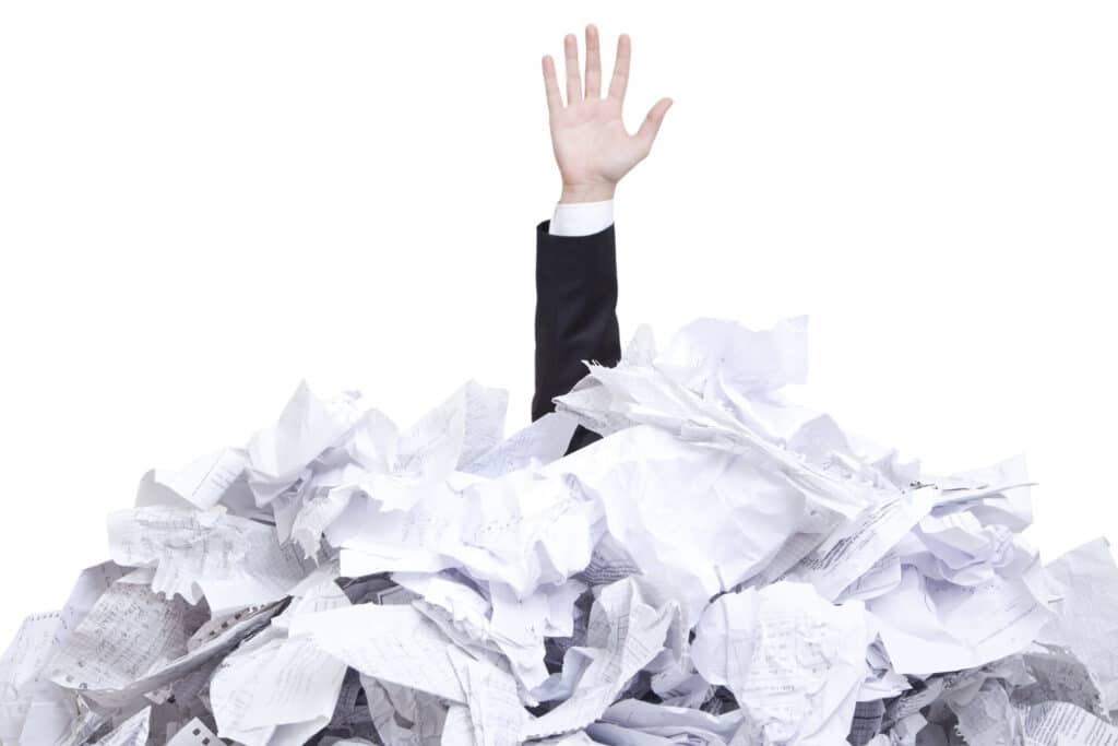 A man covered with tones of torn paper