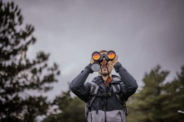 A person in nature with binoculars