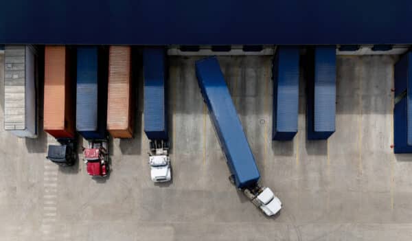 Aerial view of a truck leaving the loading dock at a distribution warehouse